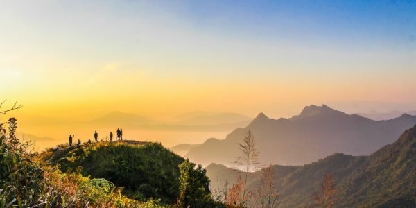 photo-of-people-standing-on-top-of-mountain-near-grasses-733162.jpg